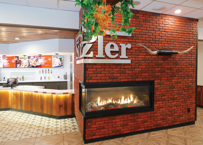 A wrap around logo and fireplace are the most dramatic elements of the new design.