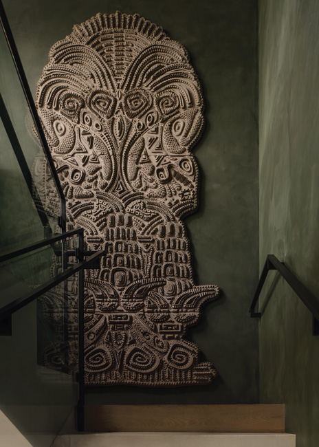 An 11-foot-tall totem inspired by the stone man is showcased at the landing on the stairs to the mezzanine.