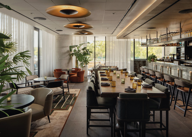 The main bar and lounge features clustered cocktail and communal table seating.