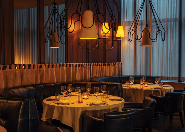 Tre Dita has one private dining room  that’s slightly elevated from the main dining area, making it part of the dining room but still separate. Image courtesy of Eric Wolfinger