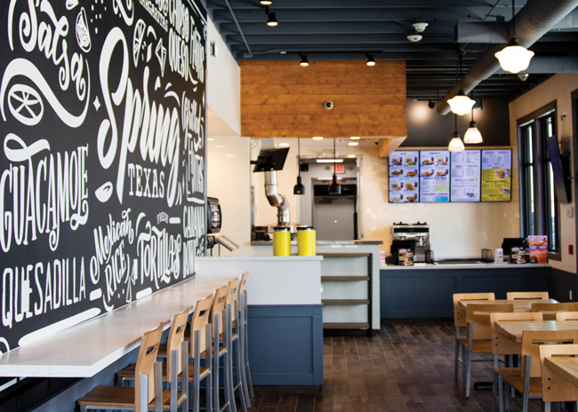 Taco Cabana’s aesthetics include bright walls and natural-looking materials. Image courtesy of Taco Cabana