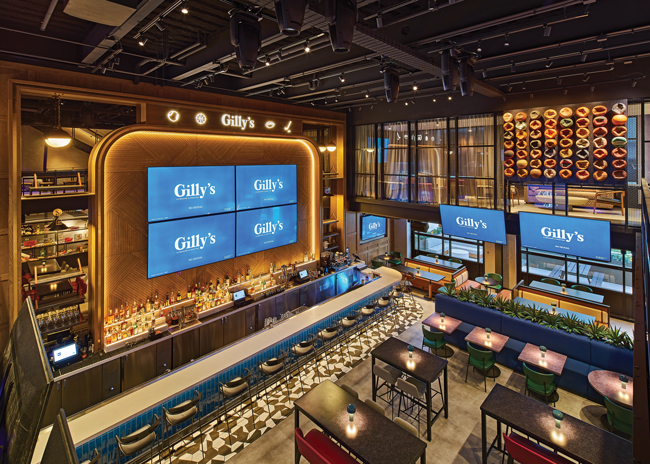 While modern and new, Gilly’s Clubhouse in Detroit draws on nostalgia to tell a story and create an emotional connection. Honoring the client’s late son, the designers sought to capture childhood excitement around sports, incorporating memorabilia collections and other elements that resonate with sports fans of any age.  Image courtesy of John D’Angelo