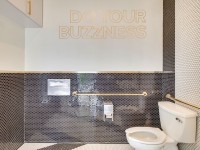 better buzz restroom w mosaic tiles and branding message
