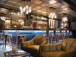 Mixed levels and types of seating encourage socializing at Charlotte's Speakeasy on Long Island. Image courtesy of Harriet Andronikides Photography